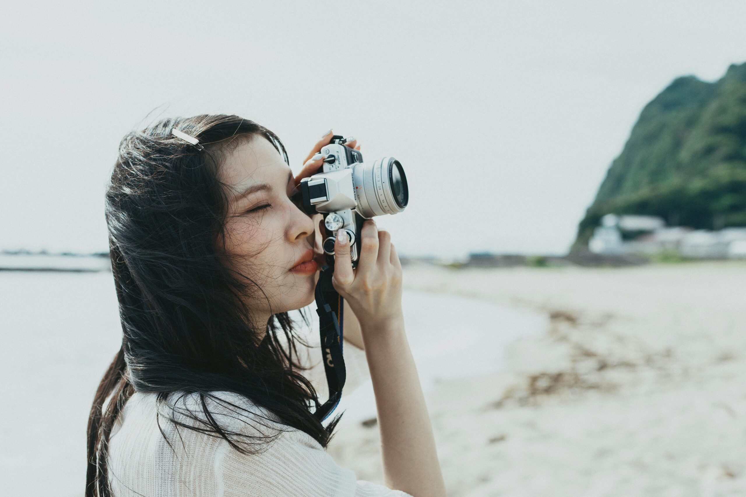 A photographer takes a shot on a scenic beach in Nishiizu, Shizuoka, Japan.